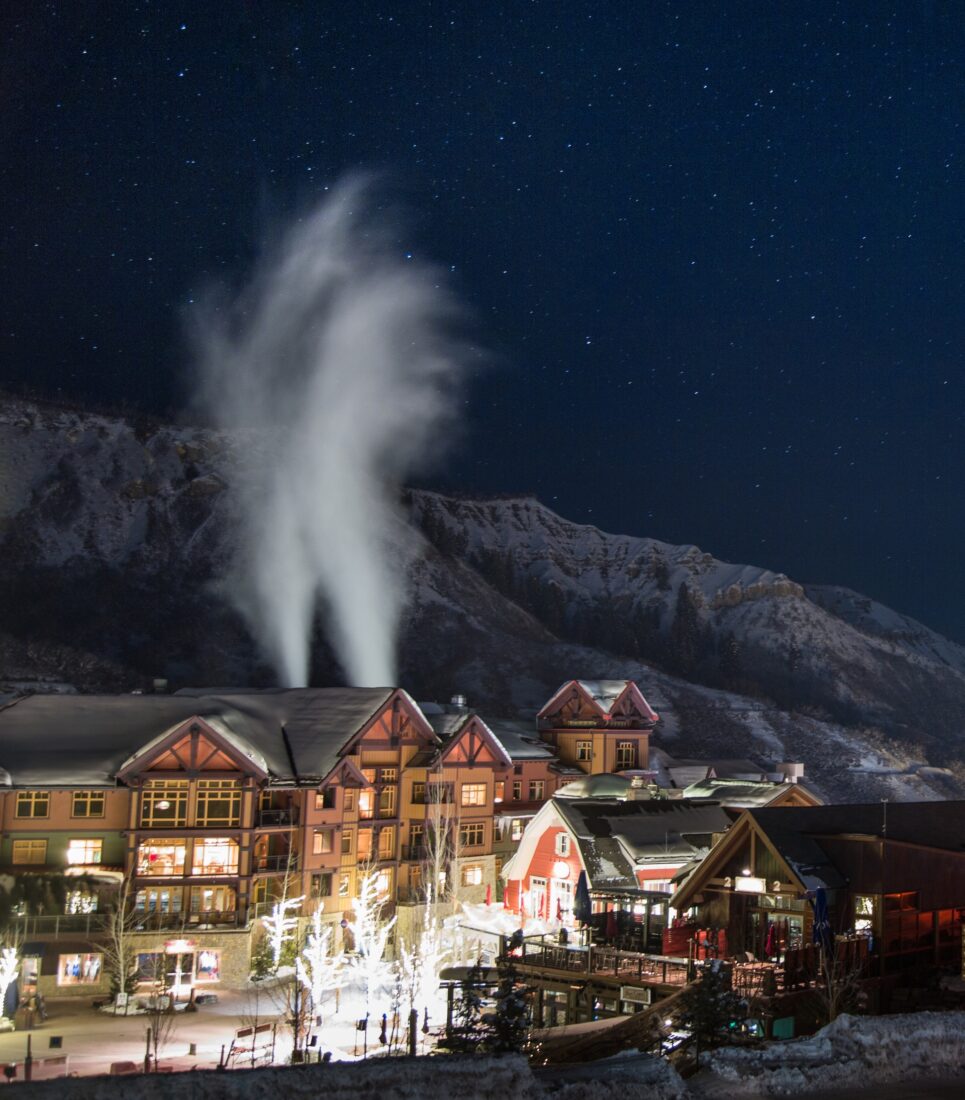 Mountain home exterior at dusk