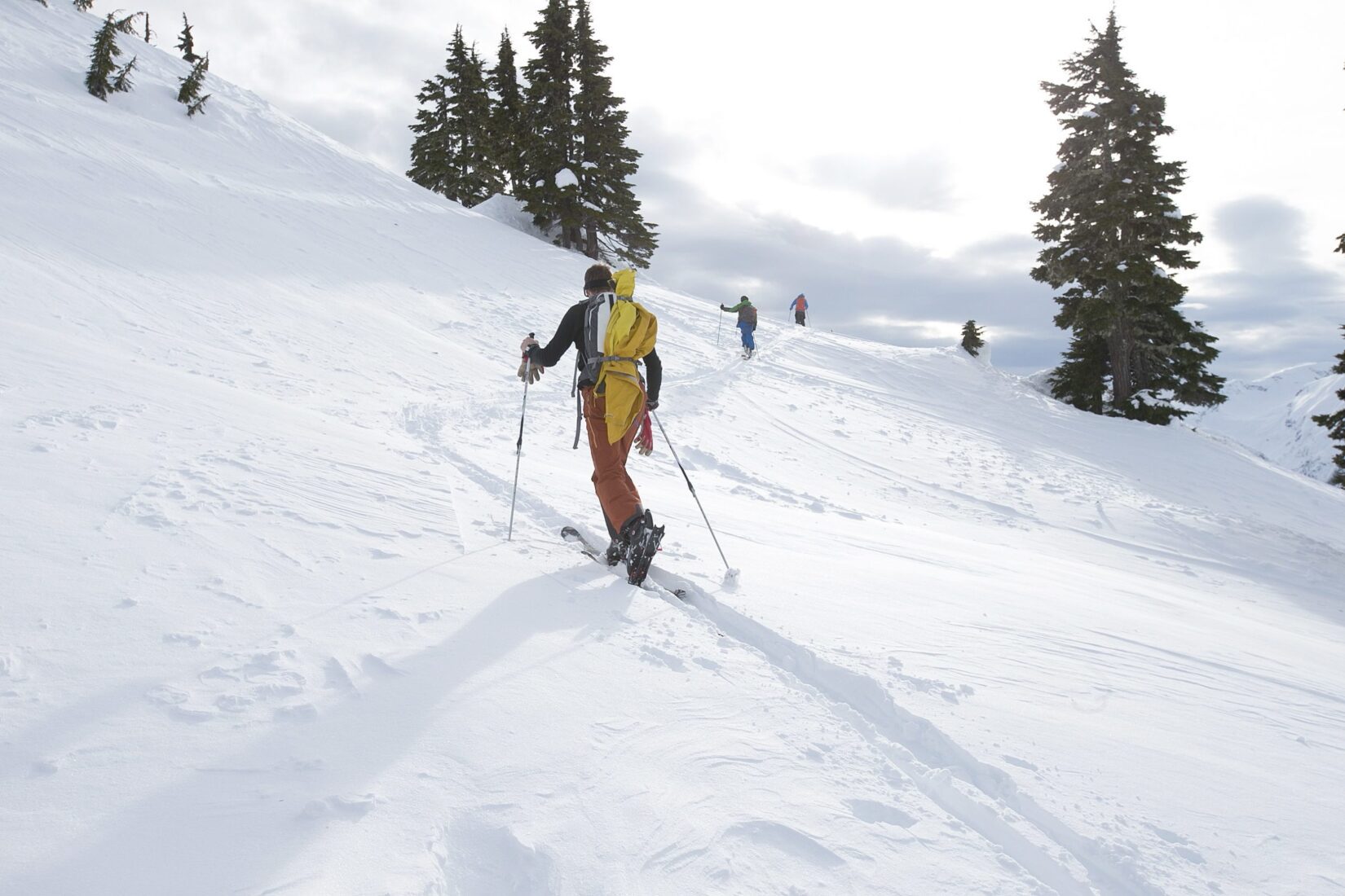 Uphill skier skinning up a snowy slope